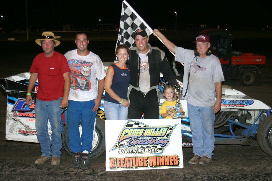 Gary Langworthy Jr. celebrates with his wife and crew after winning the USRA Modified feature at Caney Valley Speedway.