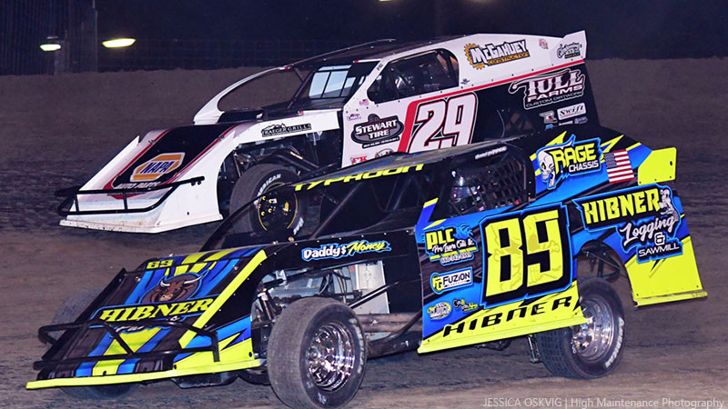 Tyler Hibner (89) and defending track champion Dennis Elliott (29) battle during USRA Modified competition at the I-35 Speedway.