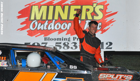 Jason Cummins of New Richland, Minn., celebrates in victory lane after winning the USRA RHS Modified main event on Friday, July 30, at the Chateau Raceway in Lansing, Minn.