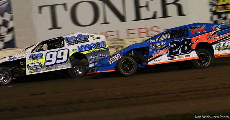 Brad Smith (99) and Andy Bryant (28) battle in the Out-Pace USRA B-Mods at Lakeside Speedway.