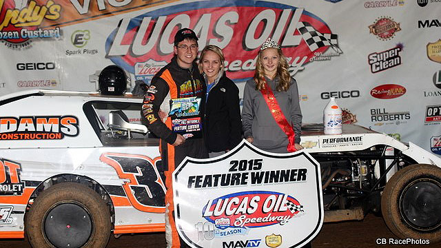 Logan Martin poses for victory lane photos on Friday with girlfriend Larissa Atnip and Miss Lucas Oil Speedway Brittney Kennedy.