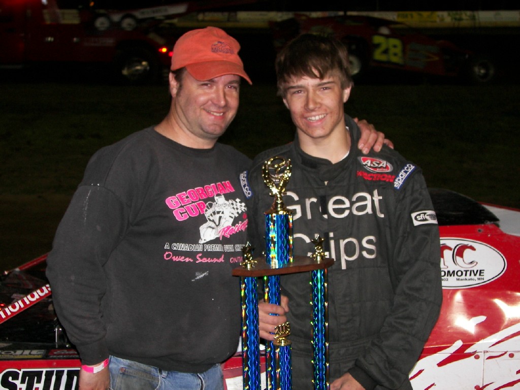 Alan Mondus celebrates in victory lane with his father, Scott, after winning Sunday's USRA Modified feature at the Cresco Speedway.