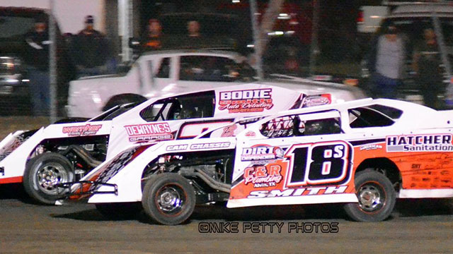 Eventual USRA Modified feature winner Cody Smith (18) races inside of Billy Brierton at the Superbowl Speedway on Saturday, March 1, 2014.
